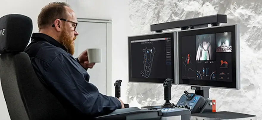 A photo of a mad sitting at a command centre for teleoperation